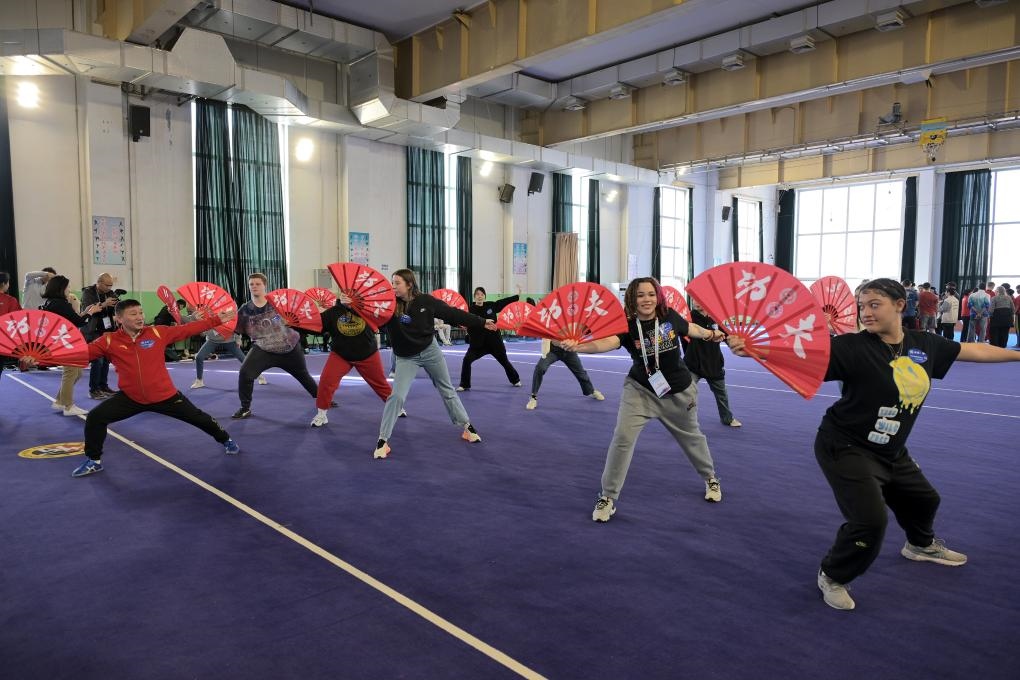 2024年3月19日，首都体育学院，美国华盛顿州中学生代表团的成员体验功夫扇。新华社记者 李鑫 摄